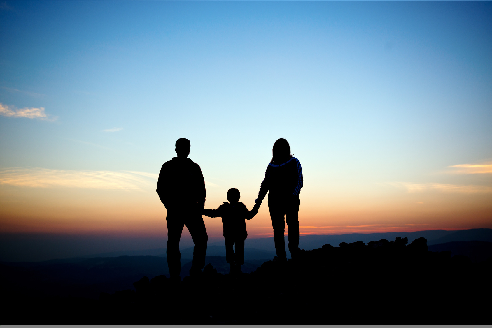 silhouette of family on the outdoor at dusk.